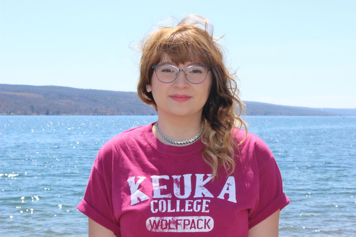 Olivia standing in front of the lake