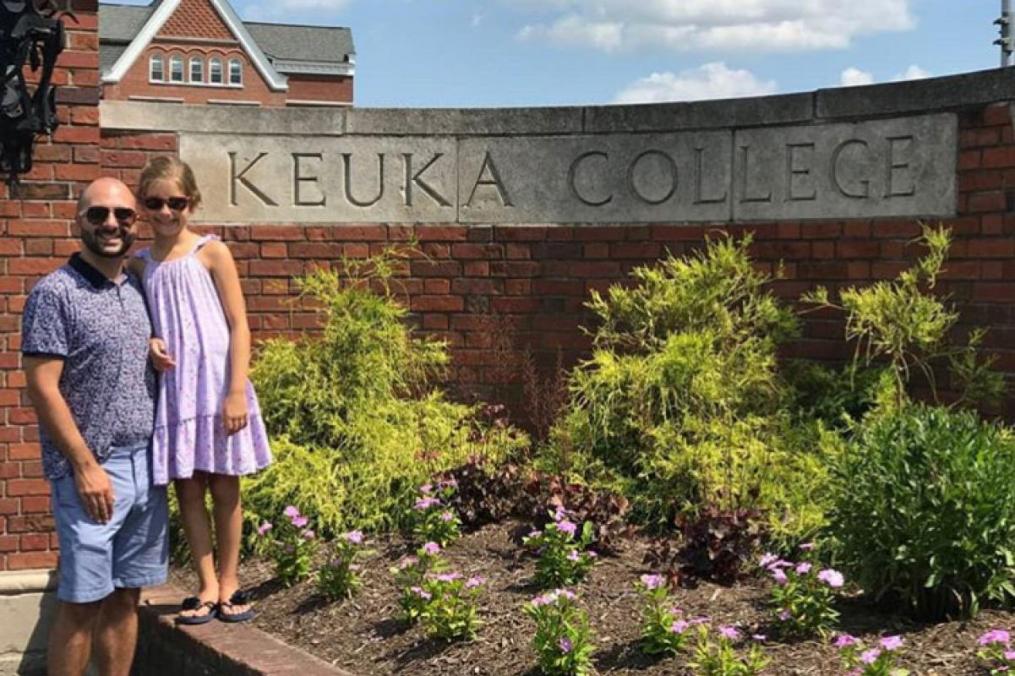  Dr. Brandon Barile '05 and his daughter, Sophia Barile-Swain, 8, stand by the front entrance of Keuka College.